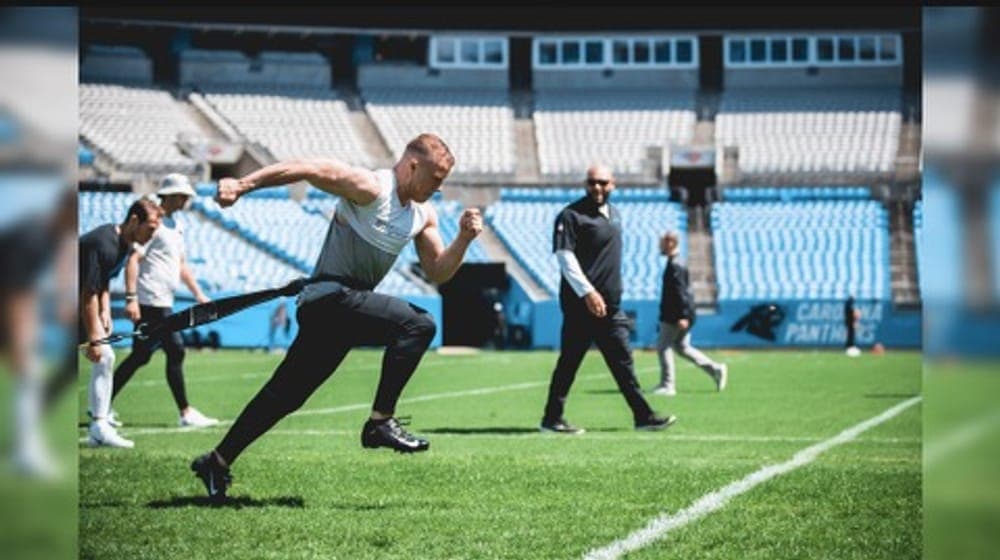 Coach Jason leading resisted-sprint work on the field